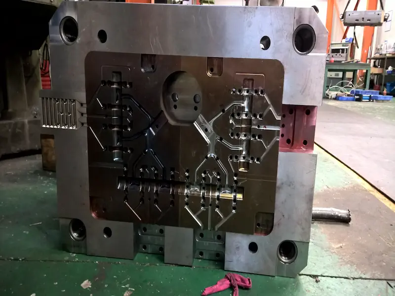 Two color injection molded plastic parts with dual-color appearance and functional design