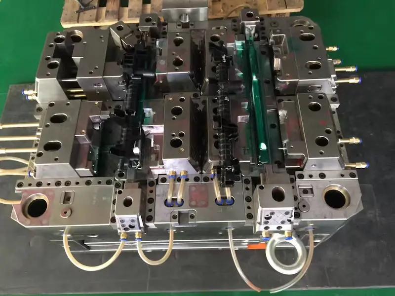 Injection molded plastic part showing silver streak and black mark surface defects