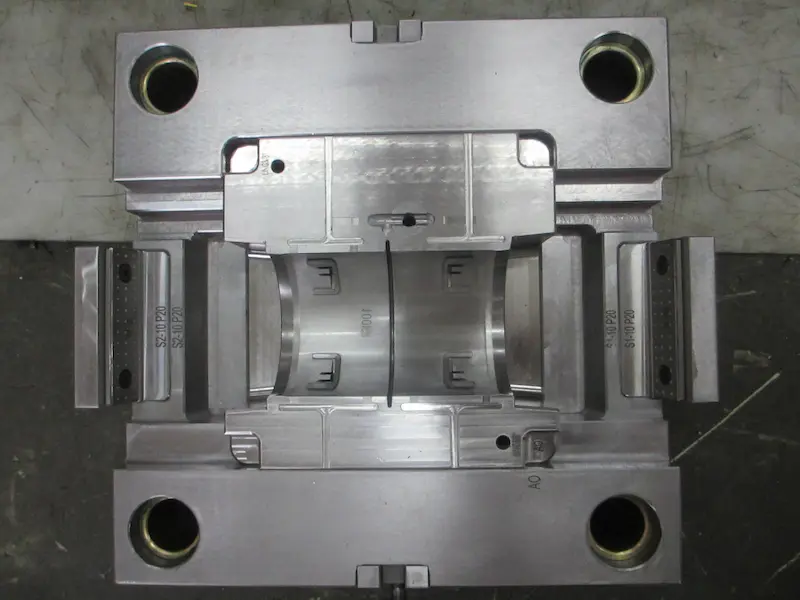 Injection molding machine showing molding pressure control during plastic part production