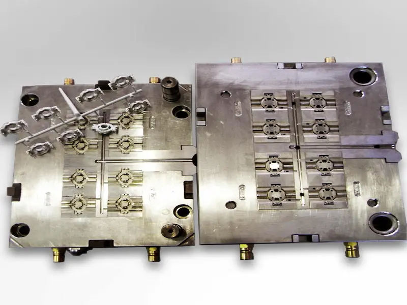 Damaged stamping die components being inspected for mold failure causes in a stamping workshop