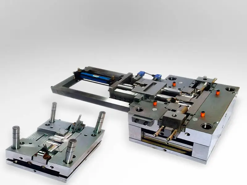 Stamping die components being inspected for repair or scrap decision in a metal stamping workshop