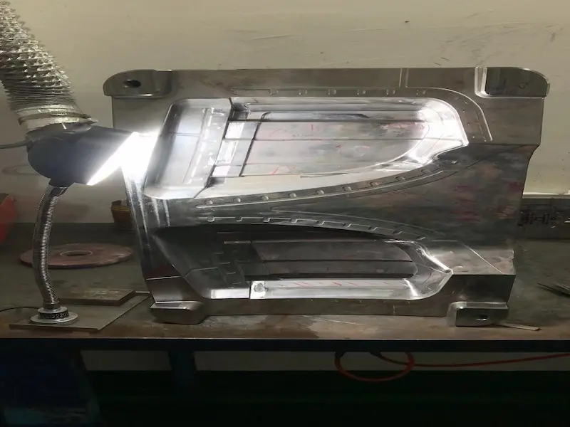 Damaged stamping die showing broken punch, worn guide post, trapped scrap, and stripper plate failure.