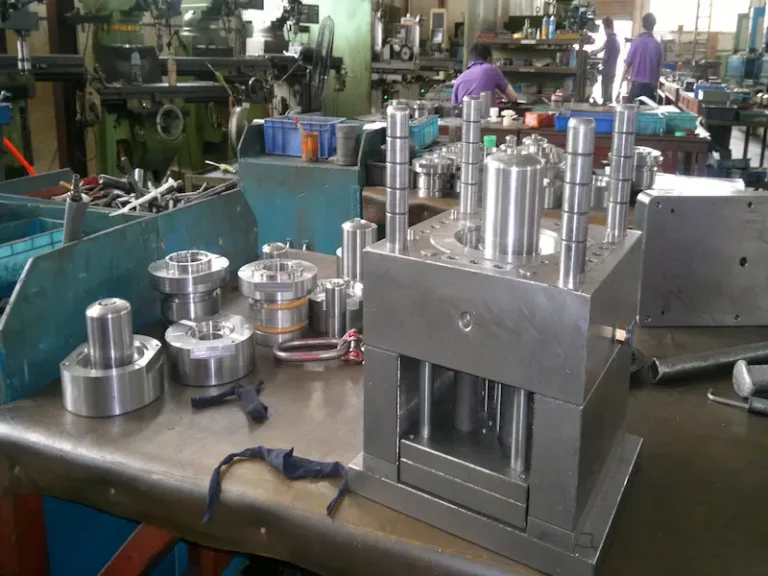 Injection molded plastic parts showing uneven gloss, dark surface areas, and appearance defects caused by molding process issues