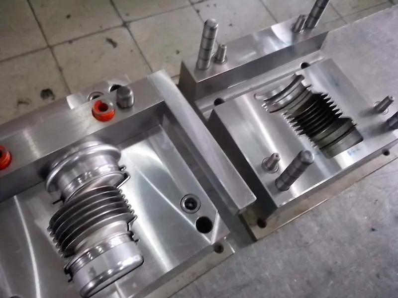 Injection molded plastic parts showing warpage, bending, and twisting caused by uneven shrinkage and internal stress