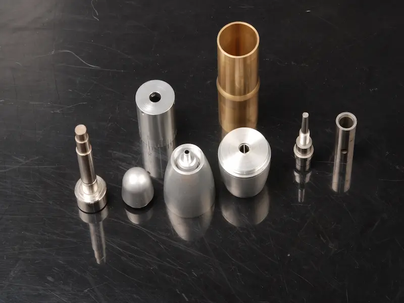 Wire EDM machining process showing electrode wire cutting a precision metal workpiece