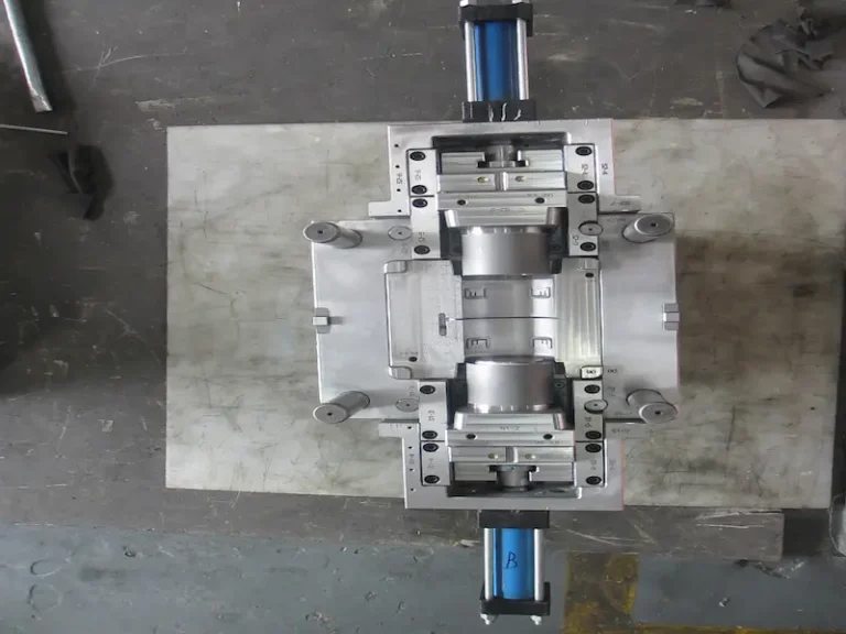 Cross-section view of a die casting mold showing cavity inserts, runners, ejector system, guide pins, venting channels, and cooling lines.