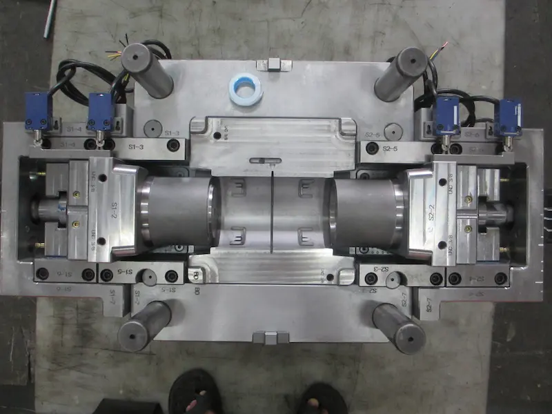 Industrial plastic drying system with resin hopper dryers, dehumidifying equipment, and plastic pellets prepared for injection molding.