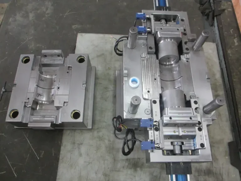 Close-up of injection molded plastic parts showing vacuum bubble defects caused by shrinkage and insufficient packing.