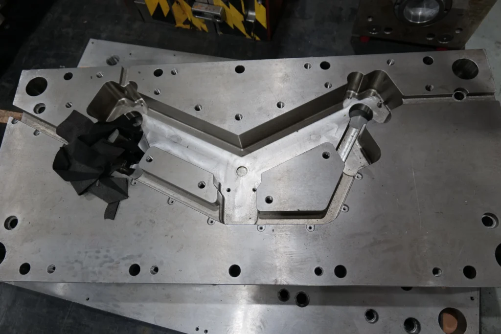 Coordinate measuring machine inspecting a precision part in a controlled quality inspection room