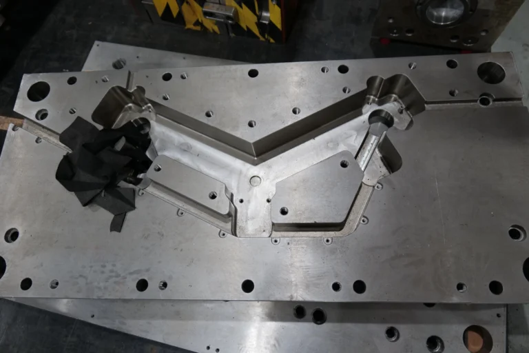 Coordinate measuring machine inspecting a precision part in a controlled quality inspection room