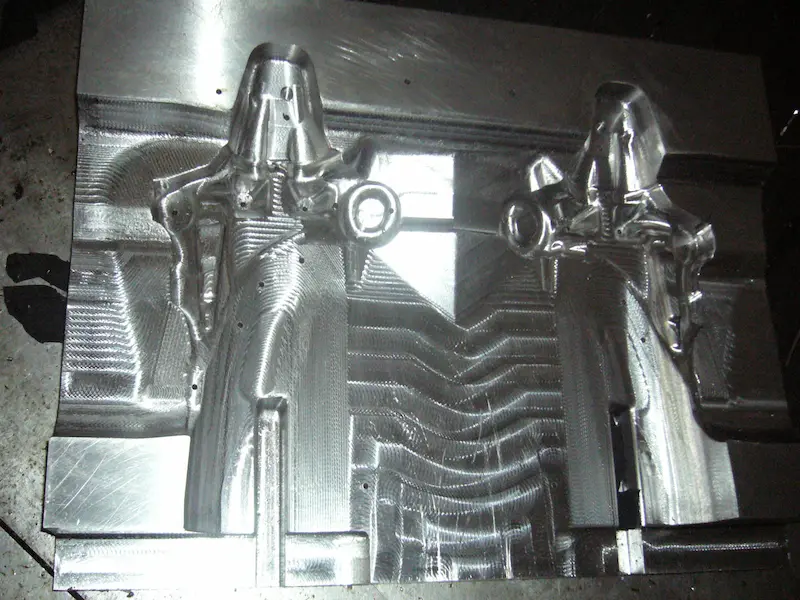 Precision stamping die polishing process showing mechanical polishing tools, mirror-finish die surfaces, and fine surface treatment methods.