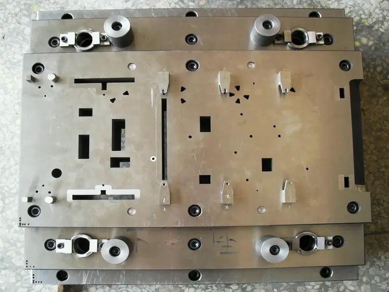 Insert molding process showing plastic resin overmolding metal inserts and integrated hybrid parts in automated production.