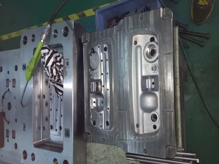 High-gloss injection mold with mirror-polished cavity, hot runner valve gate system, and glossy molded plastic parts.