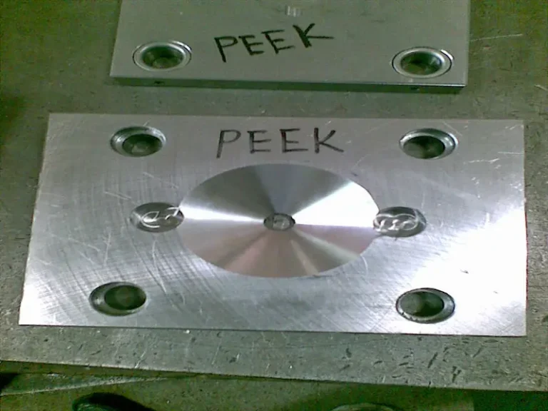 Injection molding machine nozzle and screw maintenance showing heated nozzle removal, barrel purging, and cleaning of residual plastic material.