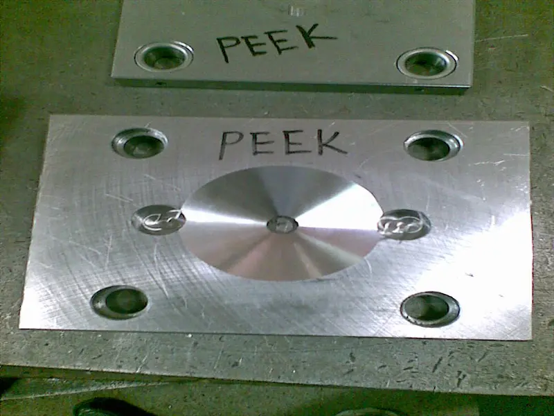 Injection molding machine nozzle and screw maintenance showing heated nozzle removal, barrel purging, and cleaning of residual plastic material.