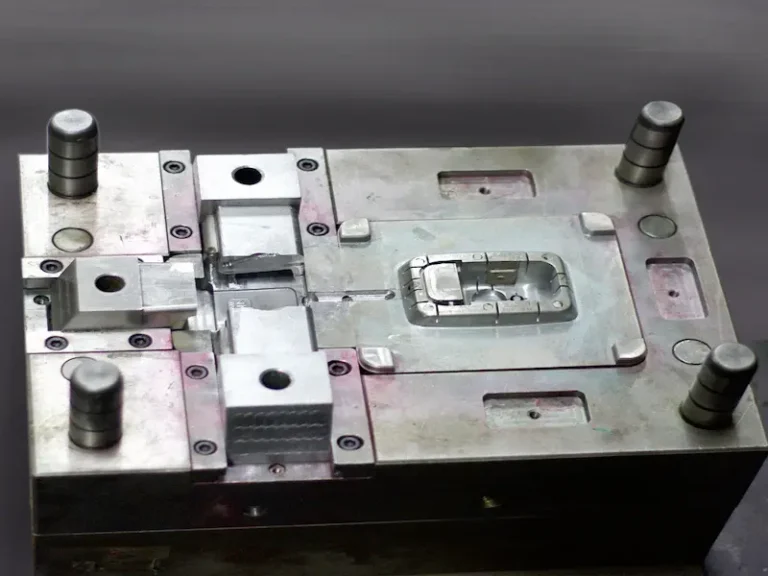 Close-up of cracked injection molded plastic parts showing surface cracks, whitening, stress marks, and mold-related defect areas.