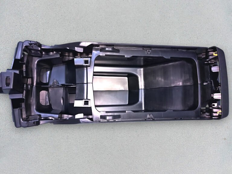 Injection molded center console rear HVAC air vent housing for automotive interior