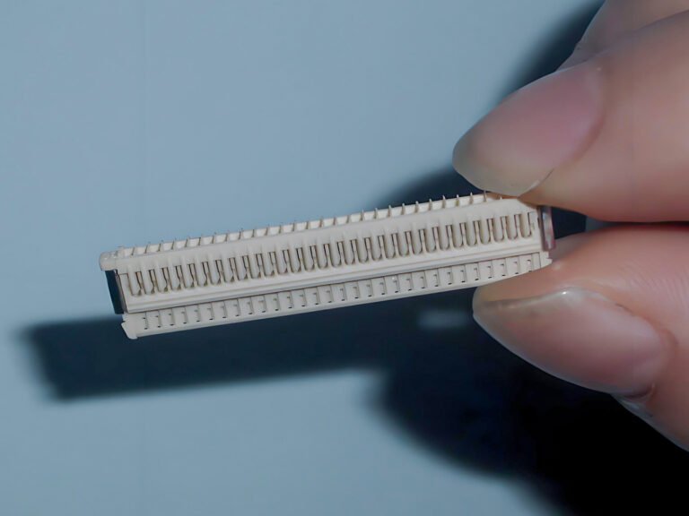 Injection molded fine-pitch electronic connector housing for electronics applications