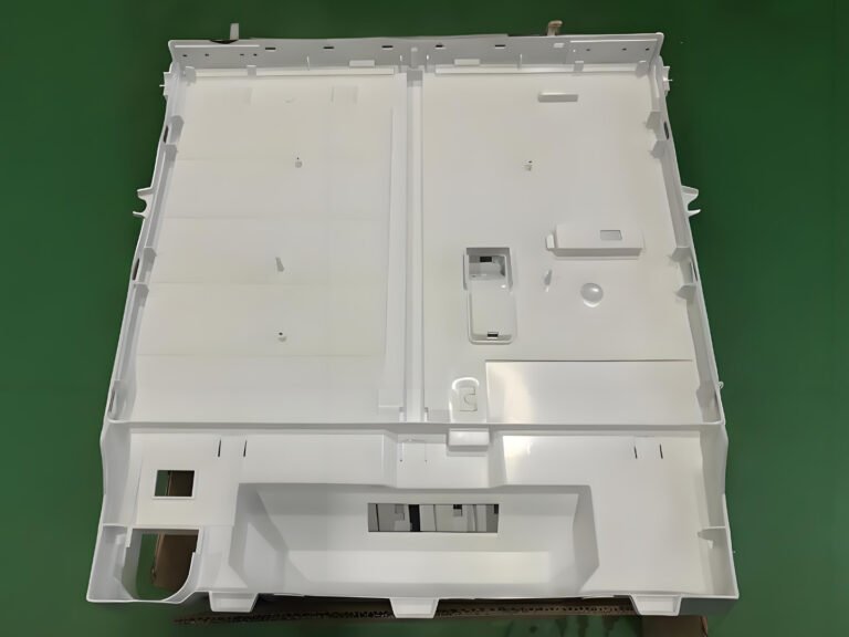 Injection molded refrigerator bottom base pan for home appliance applications
