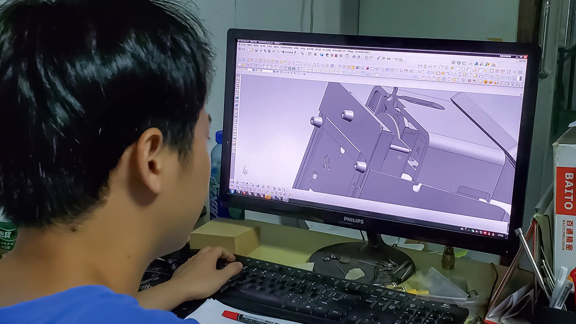 Engineer reviewing CAD design and product structure for manufacturing-oriented product development support before tooling
