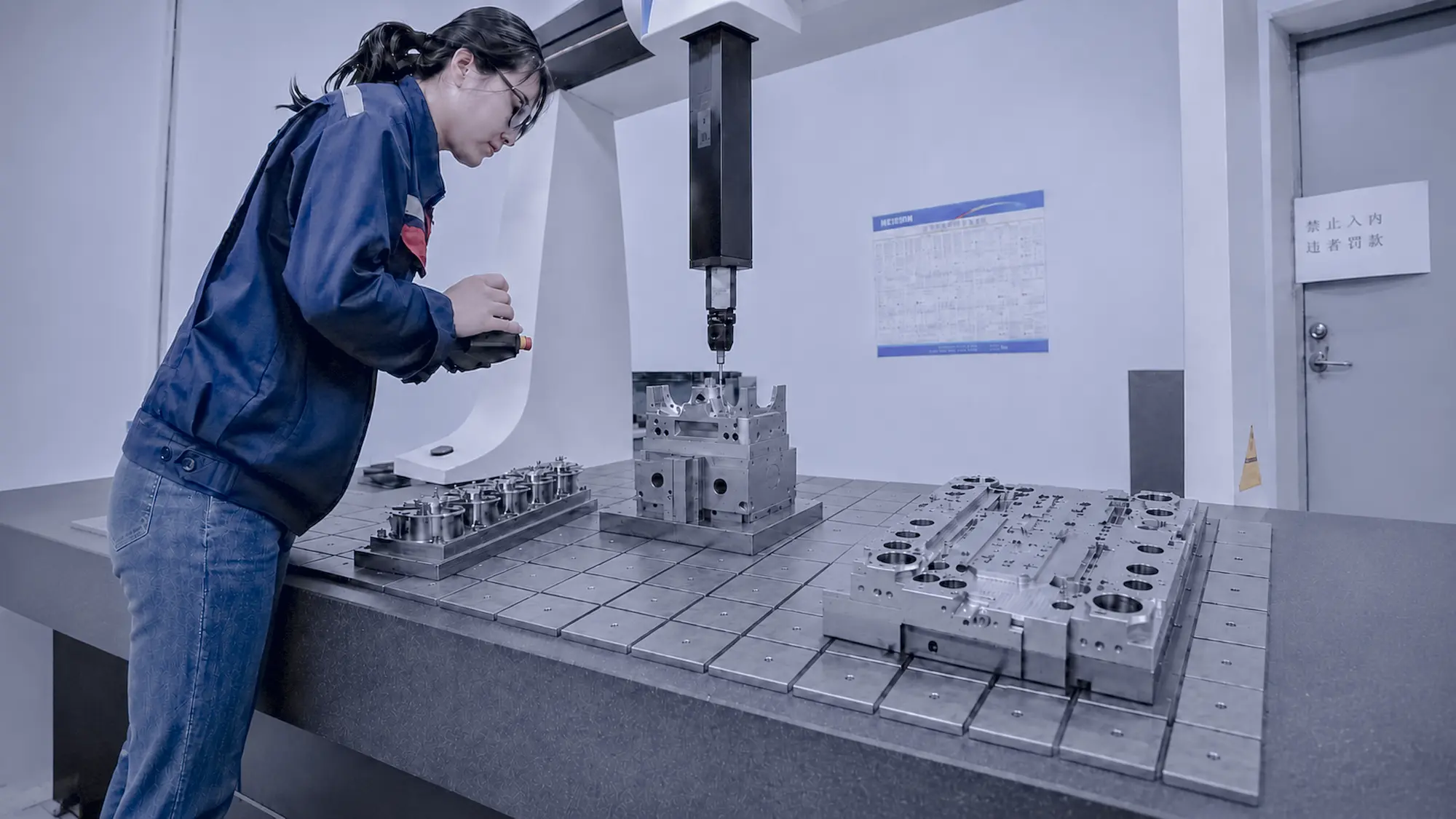 CMM measuring a precision manufactured component to verify critical dimensions, positions, and geometric tolerances